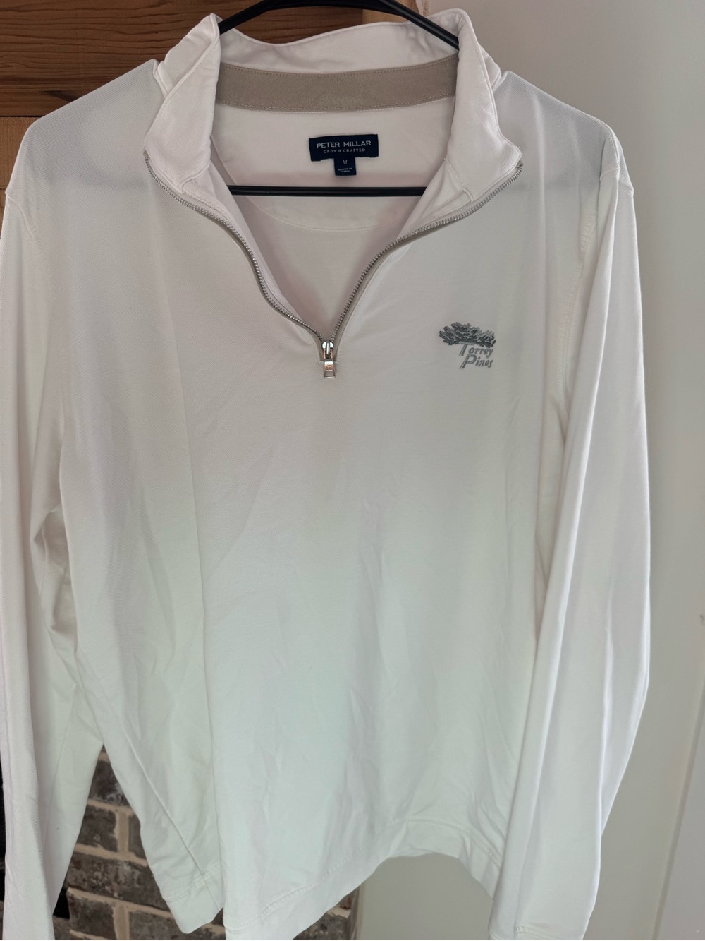 white Peter Millar quarter-zip pullover featuring an embroidered Torrey Pines go